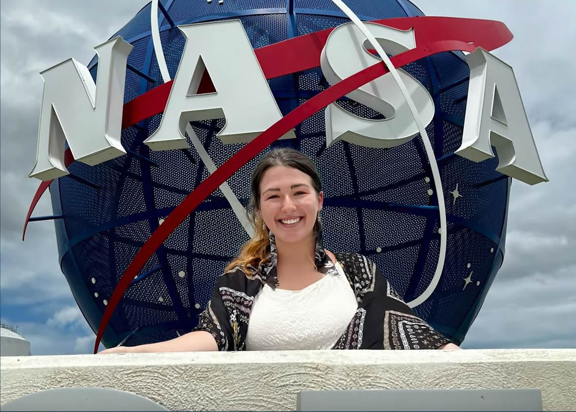 Taylor Hart next to NASA sign