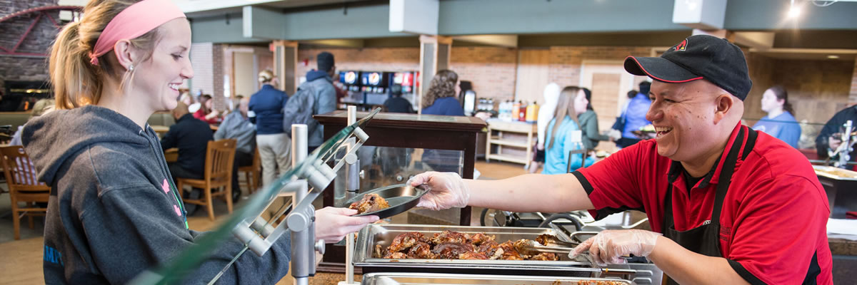 Student selecting food in dining facility