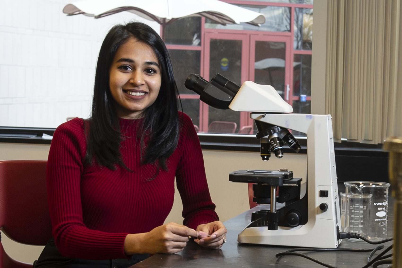 Student with microscope in lab