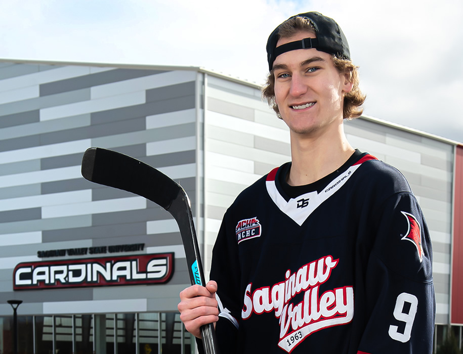 Hockey player posing with stick