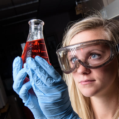 Student holding flash with liquid