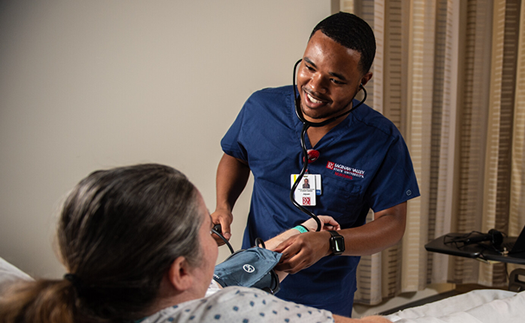 Nursing student with patient