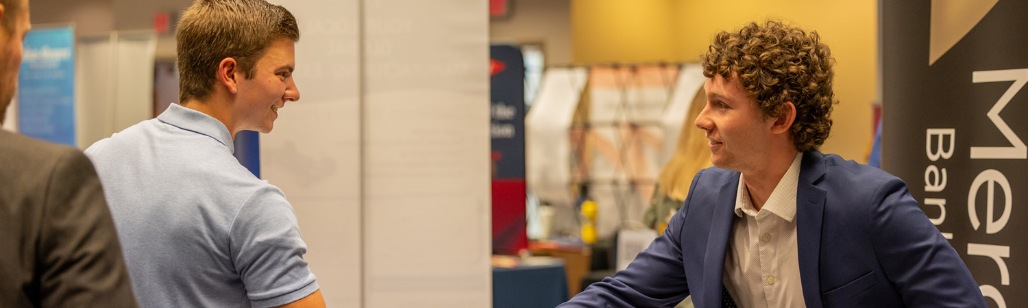 Student talking with business owner