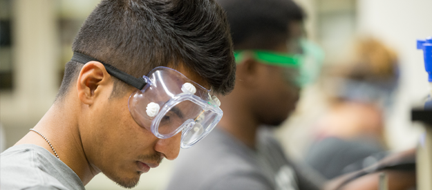 Students working in a lab with safety goggles on