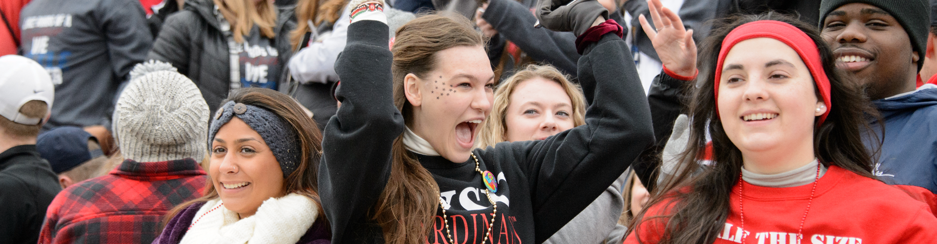 Students cheering in the bleachers of a football game at SVSU