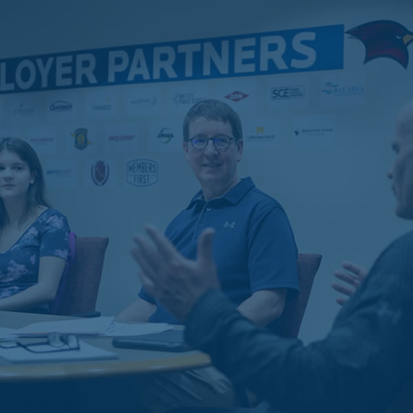 Cardinal Solutions students meeting with client