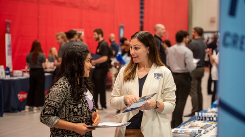 Student talking to a recruiter at employment fair