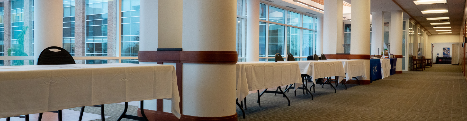 six foot tables in a line in a conference space