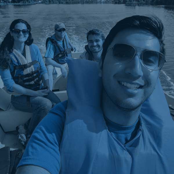 students and faculty on a boat