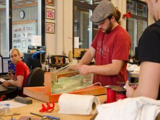 Students removing bag and seals after curing a carbon fiber component.