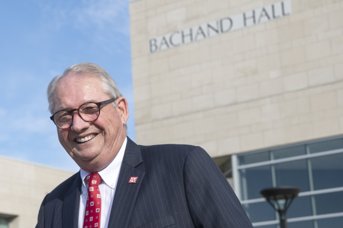 Don Bachand stands in front of the building that bears his name