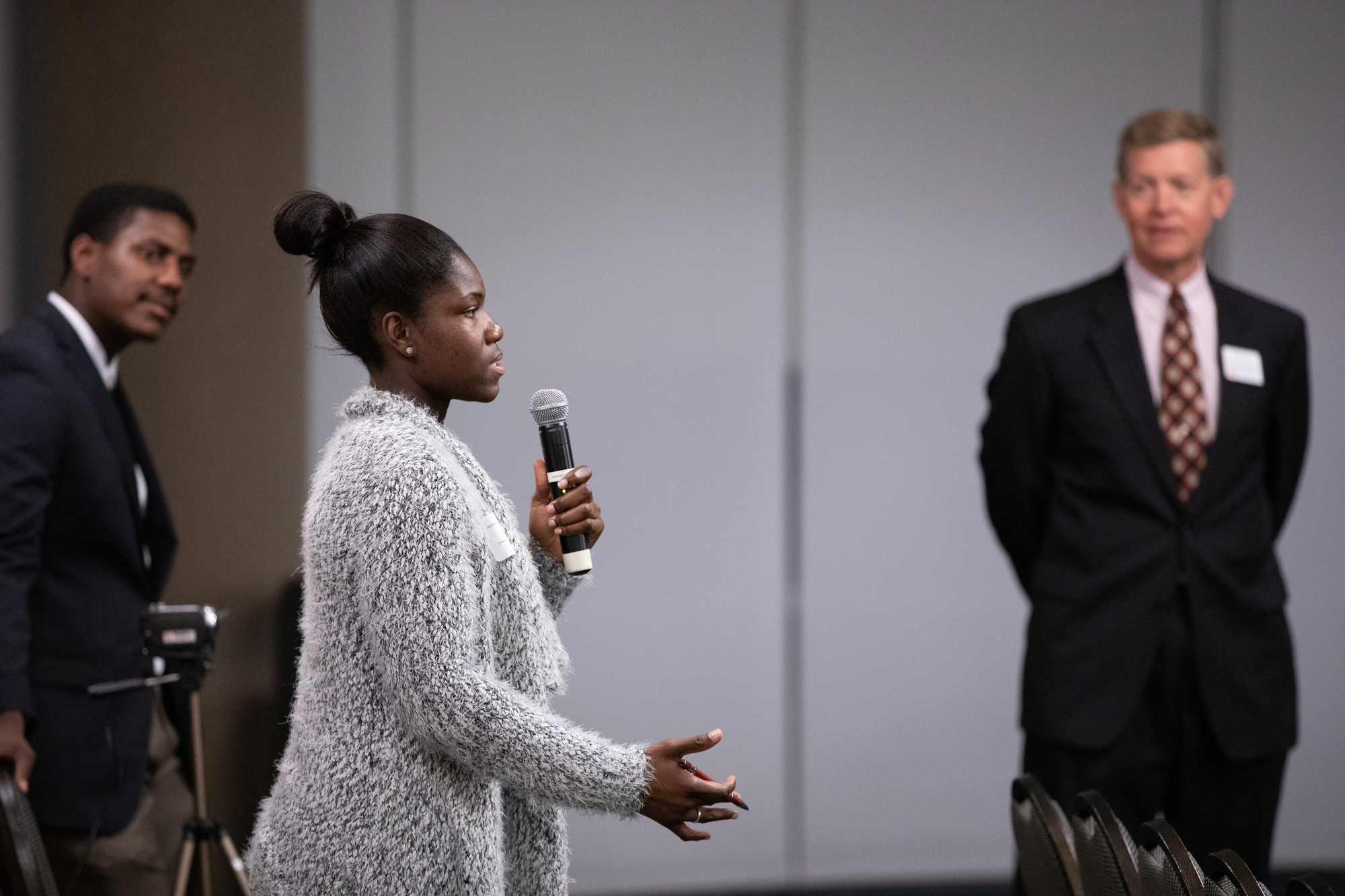 Young woman speaking into microphone