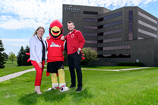 Two students with Coop the Cardinal