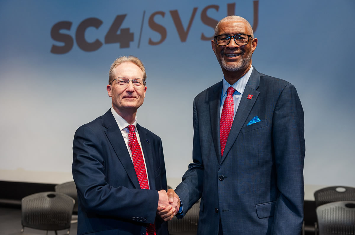 Clair County Community College President Kirk Kramer (left) and Saginaw Valley State University President George Grant Jr finalize the memorandum of understanding that establishes a partnership between the two institutions aimed at expanding higher education access in the Thumb and Southeast Michigan.