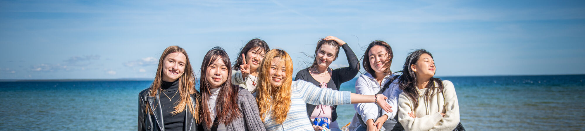 International Students Pose On A Rock