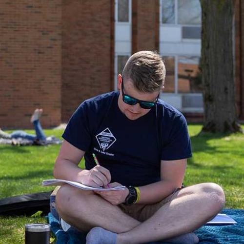 Student studying in the courtyard