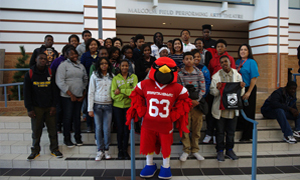 Cardinal mascot with visiting students