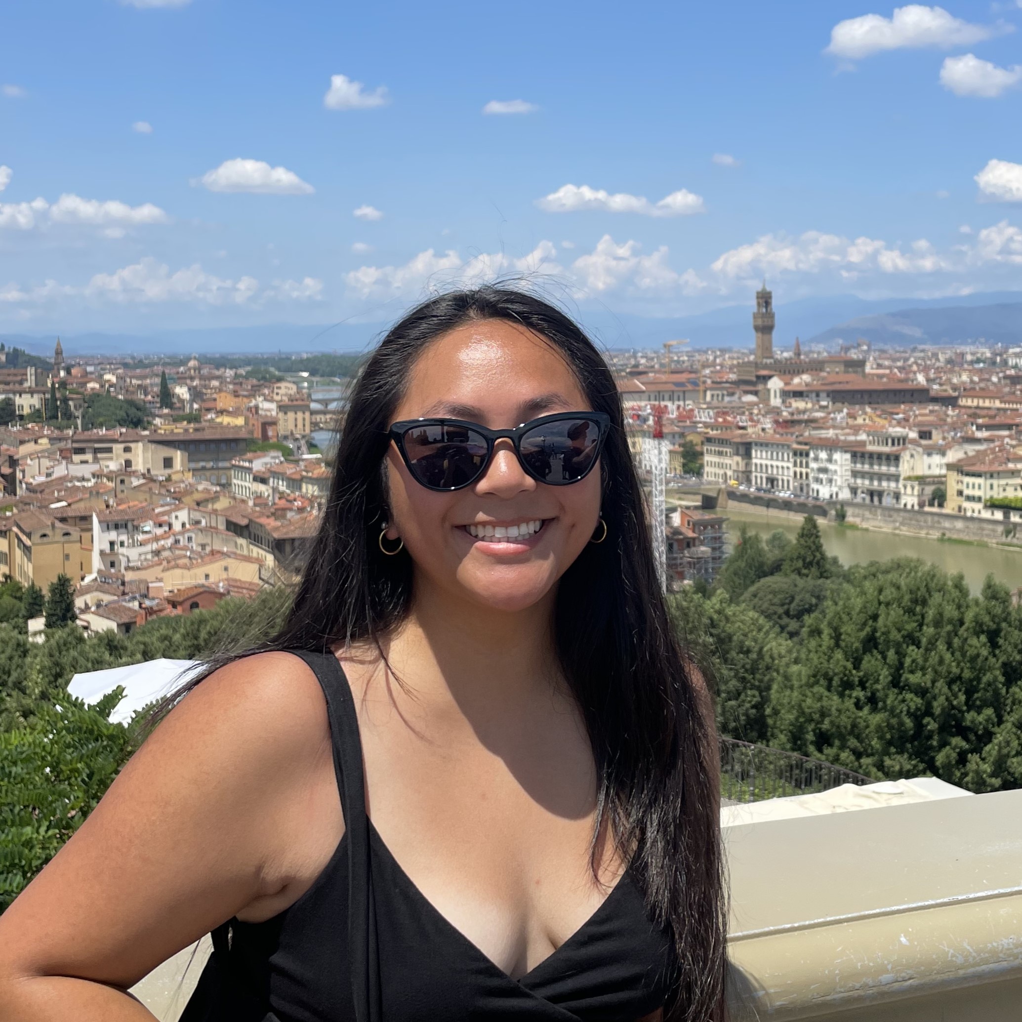 A student posing in front of an ariel view of Rome, Italy