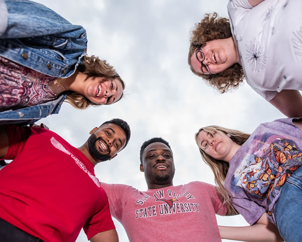 Students forming a circle with viewpoint from below