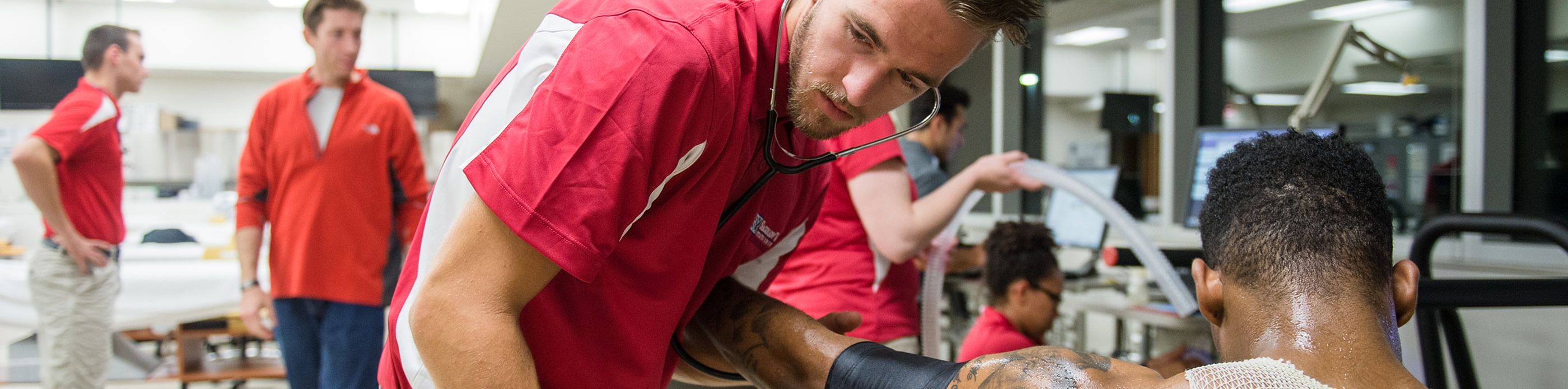 Exercise science students taking blood pressure