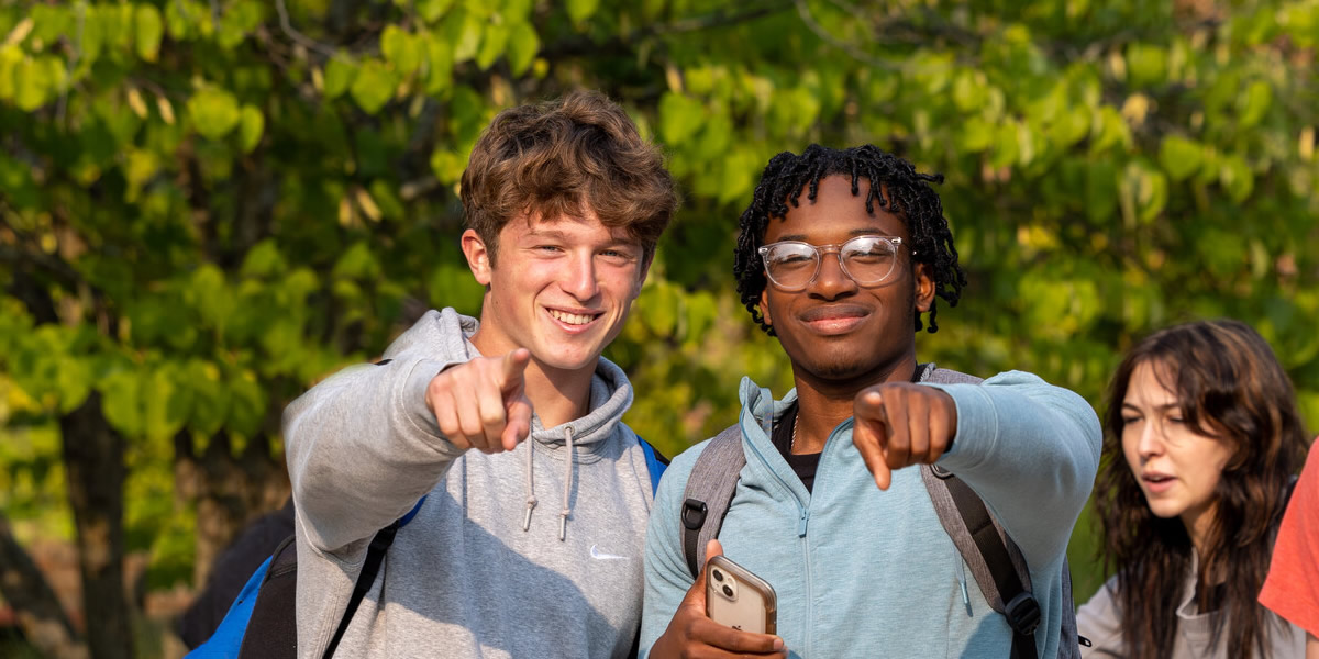 Students posing for photo while outside and walking